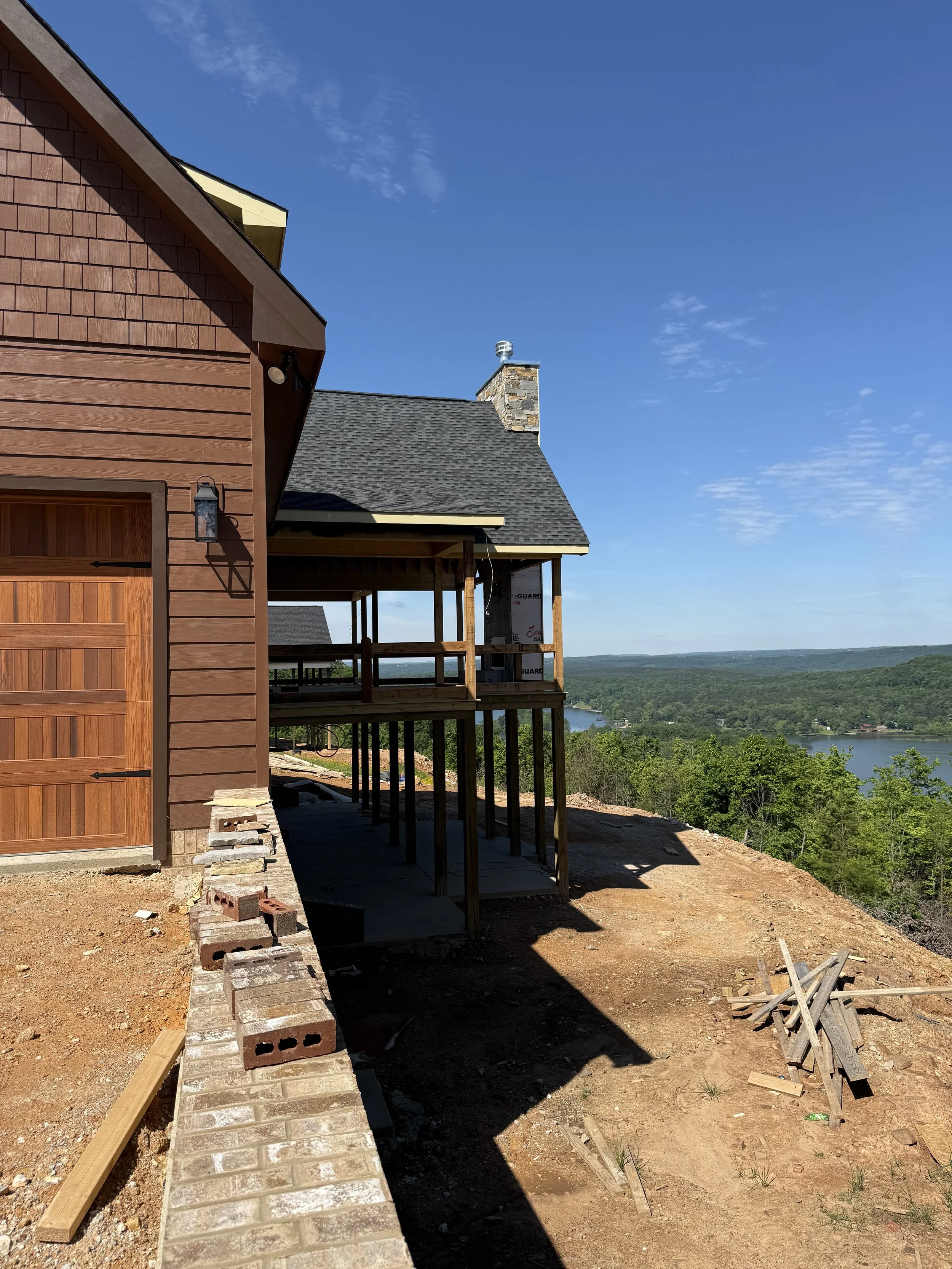 Custom home exterior at The Bluffs, cedar-shake craftsman style